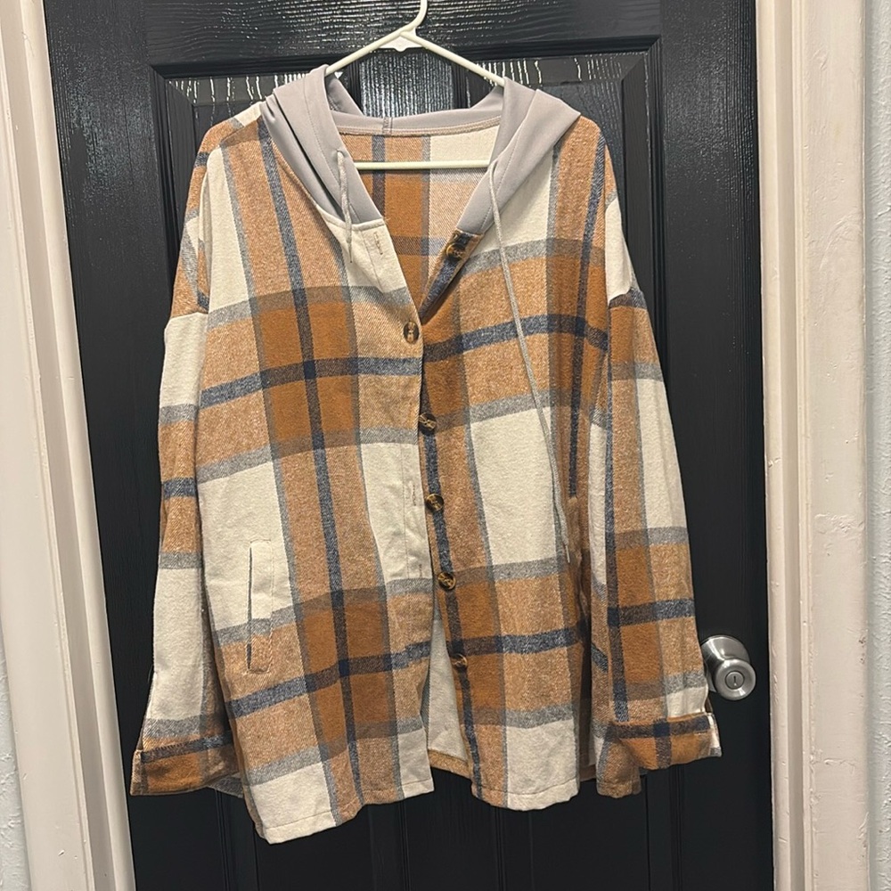 The flannel and the tan shirt are 2X in the black-and-white stripe is 3X